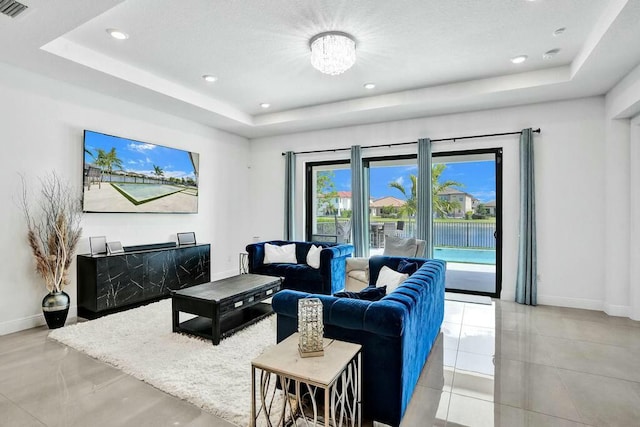 12170 N Baypoint Cir, Parkland, FL 33076 - living room featuring baseboards, visible vents, recessed lighting, and a tray ceiling