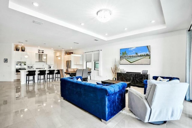 12170 N Baypoint Cir, Parkland, FL 33076 - living area featuring visible vents, recessed lighting, and a tray ceiling