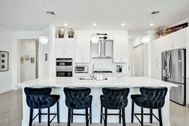 12170 N Baypoint Cir, Parkland, FL 33076 - kitchen with a sink, appliances with stainless steel finishes, visible vents, a toaster, and wall chimney exhaust hood