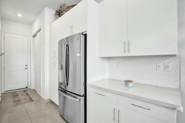 12170 N Baypoint Cir, Parkland, FL 33076 - kitchen featuring tasteful backsplash, light tile patterned floors, stainless steel fridge, light countertops, and white cabinetry
