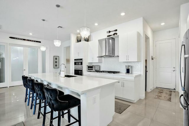 12170 N Baypoint Cir, Parkland, FL 33076 - kitchen with light tile patterned floors, a sink, appliances with stainless steel finishes, visible vents, and wall chimney exhaust hood