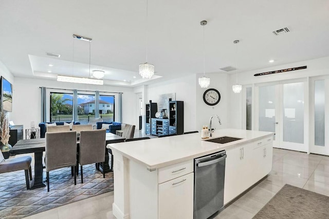12170 N Baypoint Cir, Parkland, FL 33076 - kitchen featuring dishwasher, a sink, visible vents, a raised ceiling, and open floor plan