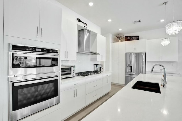 12170 N Baypoint Cir, Parkland, FL 33076 - kitchen with a sink, wall chimney exhaust hood, visible vents, light countertops, and appliances with stainless steel finishes