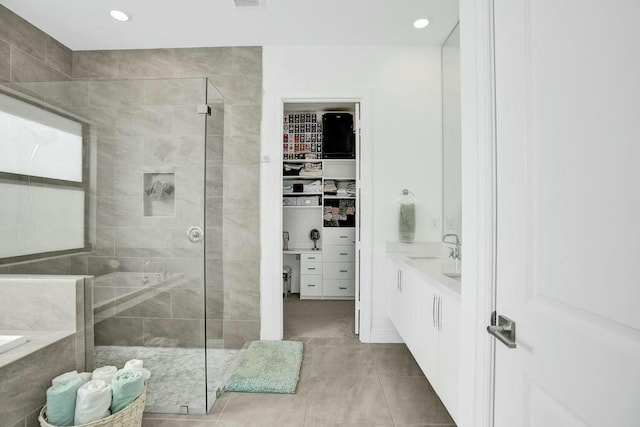 12170 N Baypoint Cir, Parkland, FL 33076 - bathroom with a stall shower, a tub, vanity, tile patterned flooring, and a walk in closet