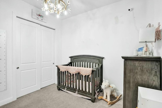 12170 N Baypoint Cir, Parkland, FL 33076 - bedroom with a crib, a notable chandelier, a closet, and carpet floors