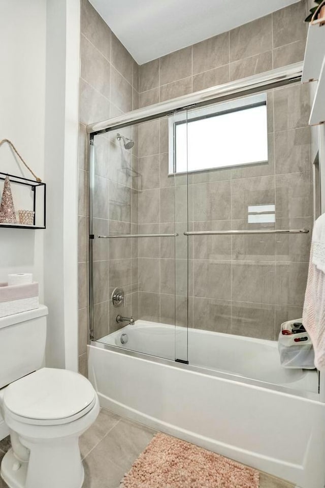 12170 N Baypoint Cir, Parkland, FL 33076 - bathroom featuring tile patterned floors, enclosed tub / shower combo, and toilet