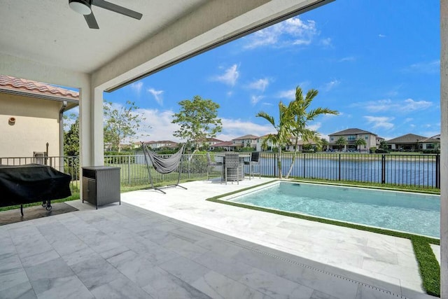 12170 N Baypoint Cir, Parkland, FL 33076 - view of pool with a fenced in pool, ceiling fan, a fenced backyard, and a water view