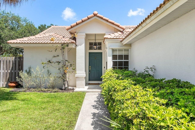 3803 S Lancewood Pl, Delray Beach, FL 33445 - entrance to property with fence, stucco siding, a yard, and a tile roof