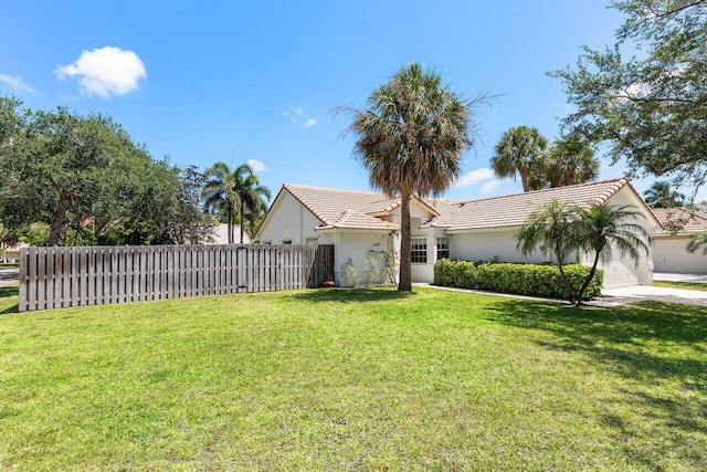 3803 S Lancewood Pl, Delray Beach, FL 33445 - view of front of house with stucco siding, fence, a tile roof, and a front lawn