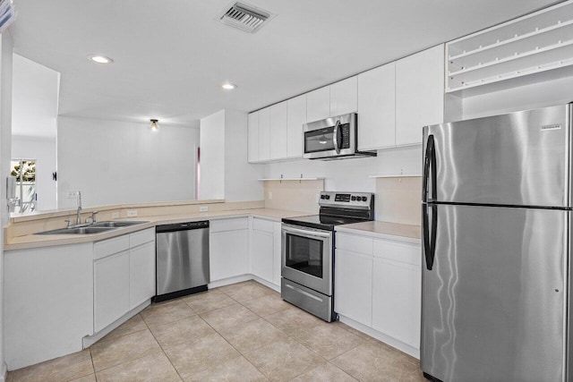 3803 S Lancewood Pl, Delray Beach, FL 33445 - kitchen with light tile patterned flooring, a sink, light countertops, stainless steel appliances, and visible vents