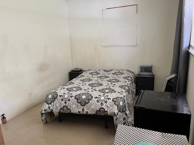 1164 NW 45th Ave, Lauderhill, FL 33313 - tiled bedroom with baseboards