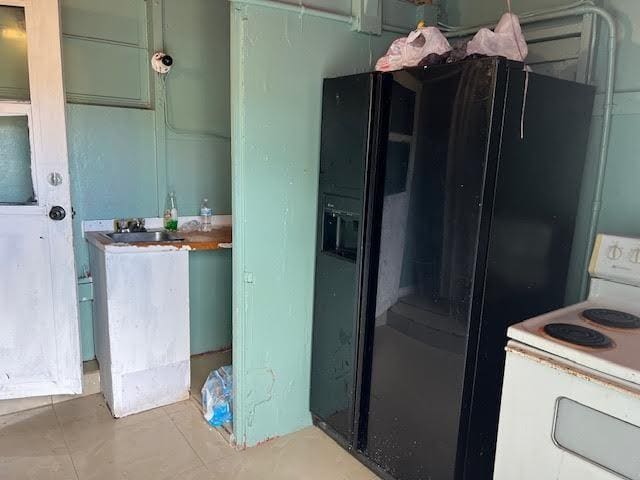 1164 NW 45th Ave, Lauderhill, FL 33313 - kitchen with electric stove, black refrigerator with ice dispenser, and a sink