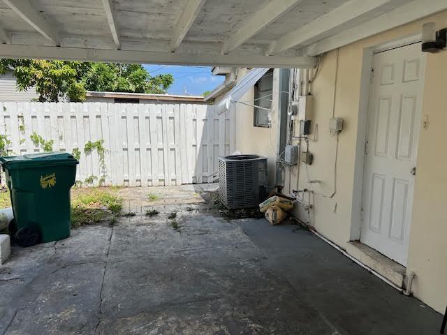 1164 NW 45th Ave, Lauderhill, FL 33313 - view of patio / terrace featuring fence and cooling unit