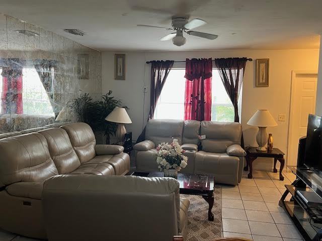 1164 NW 45th Ave, Lauderhill, FL 33313 - living room with visible vents, light tile patterned floors, and ceiling fan