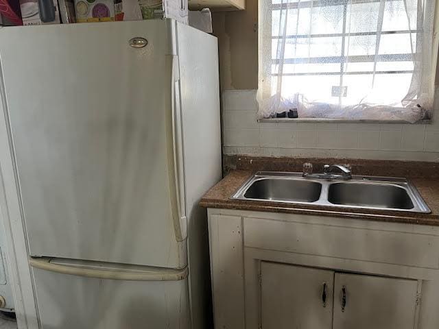 1164 NW 45th Ave, Lauderhill, FL 33313 - kitchen featuring white cabinetry, a sink, plenty of natural light, and freestanding refrigerator