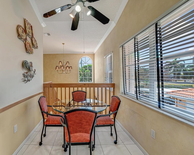dining room featuring visible vents, crown molding, tile patterned floors, baseboards, and ceiling fan with notable chandelier