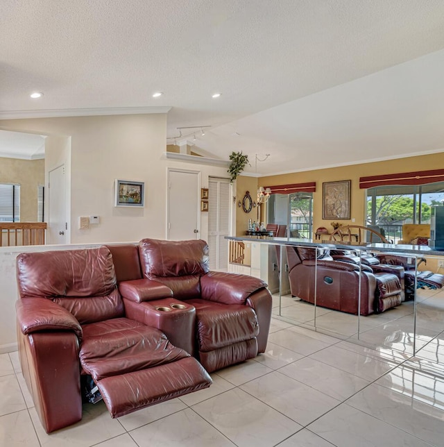 living area with recessed lighting, rail lighting, a textured ceiling, and ornamental molding