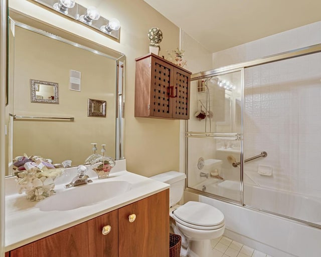 full bathroom with toilet, tile patterned floors, enclosed tub / shower combo, and vanity