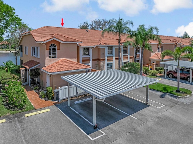 exterior space with a residential view and covered and uncovered parking