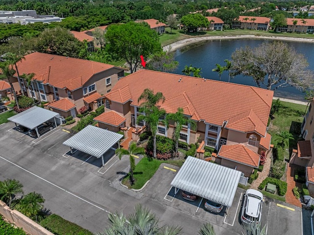 drone / aerial view with a water view and a residential view