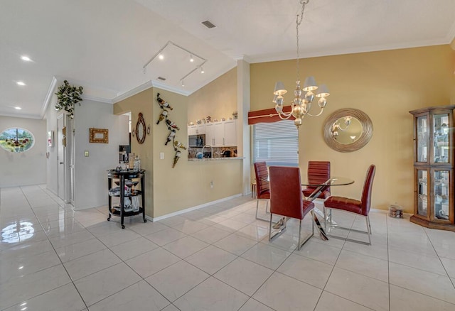 dining room with crown molding, a chandelier, light tile patterned floors, and lofted ceiling