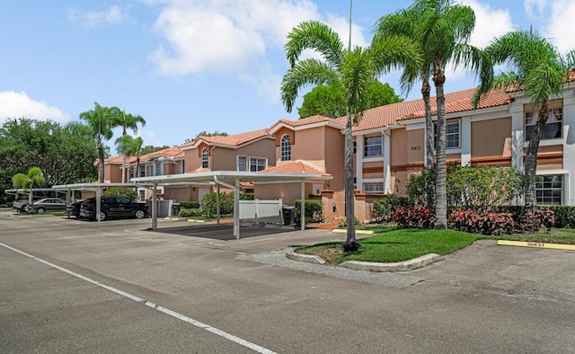 view of property featuring a residential view and covered and uncovered parking