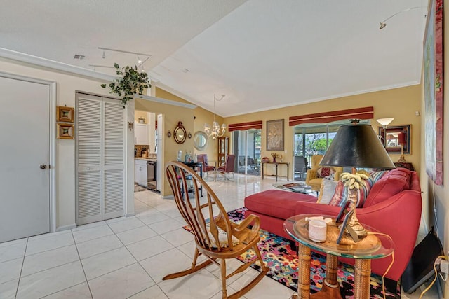 living room featuring visible vents, a chandelier, rail lighting, light tile patterned floors, and vaulted ceiling
