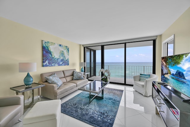 living area with light tile patterned floors and a wall of windows