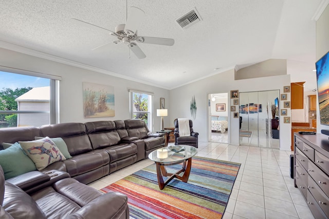 living room with visible vents, ceiling fan, vaulted ceiling, and plenty of natural light