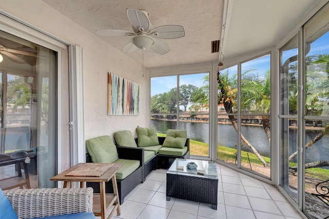 sunroom / solarium with an outdoor hangout area, a ceiling fan, and a water view