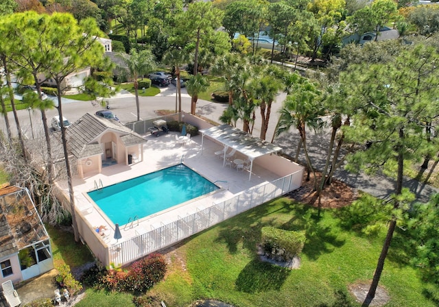 pool featuring fence and a patio area