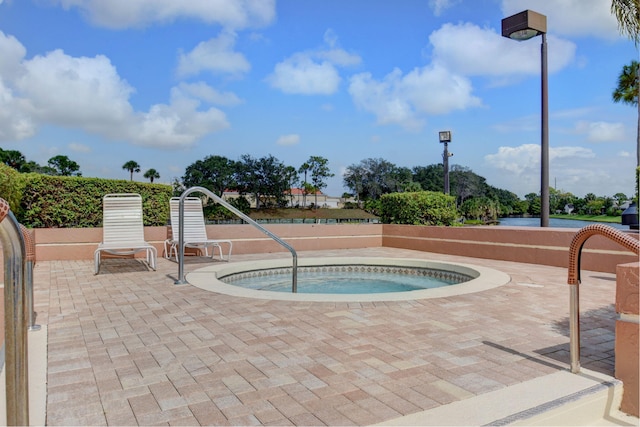 view of swimming pool featuring a patio area and a community hot tub