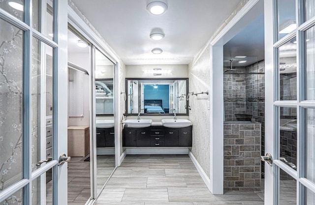 621 NW 71st Ave, Plantation, FL 33317 - bathroom featuring double vanity and a tile shower