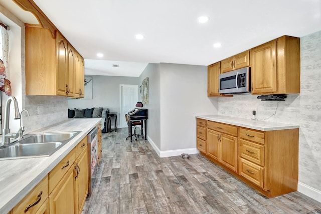 621 NW 71st Ave, Plantation, FL 33317 - kitchen featuring stainless steel microwave, a sink, wood finished floors, baseboards, and light countertops