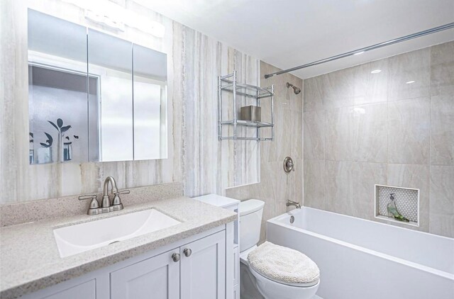 621 NW 71st Ave, Plantation, FL 33317 - bathroom featuring toilet, vanity, tub / shower combination, and tile walls