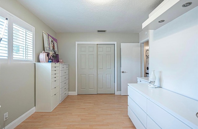 621 NW 71st Ave, Plantation, FL 33317 - bedroom with light wood-style floors, a textured ceiling, a closet, and baseboards
