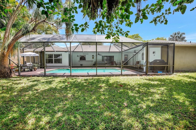 621 NW 71st Ave, Plantation, FL 33317 - rear view of house featuring a lawn, stucco siding, an outdoor pool, ceiling fan, and a patio area