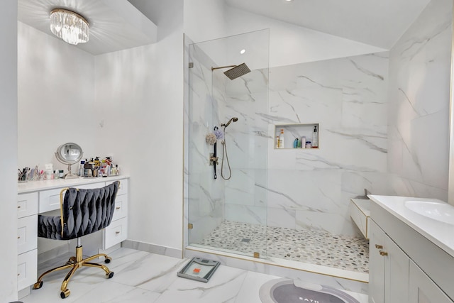 bathroom with vanity, marble finish floor, baseboards, and a marble finish shower