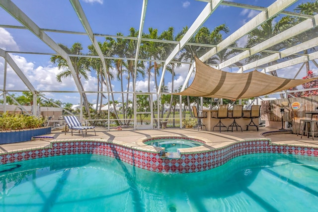 outdoor pool with outdoor dry bar, a lanai, an in ground hot tub, and a patio area