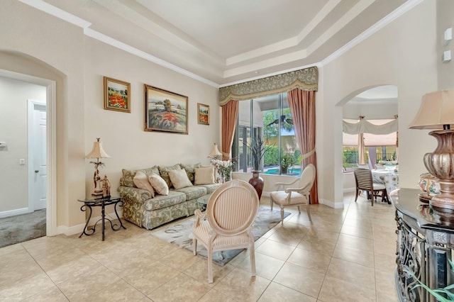16211 Rosecroft Ter, Delray Beach, FL 33446 - living room featuring arched walkways, light tile patterned floors, a tray ceiling, and ornamental molding