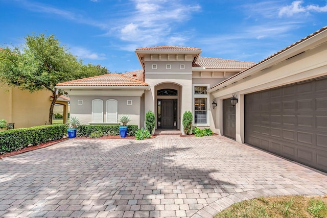 16211 Rosecroft Ter, Delray Beach, FL 33446 - view of front of home with a garage, decorative driveway, stucco siding, and a tile roof
