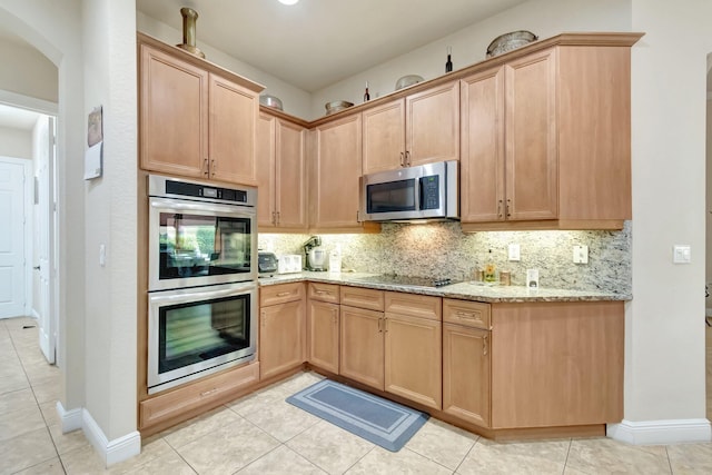 16211 Rosecroft Ter, Delray Beach, FL 33446 - kitchen with light brown cabinetry, light stone countertops, stainless steel appliances, light tile patterned floors, and tasteful backsplash