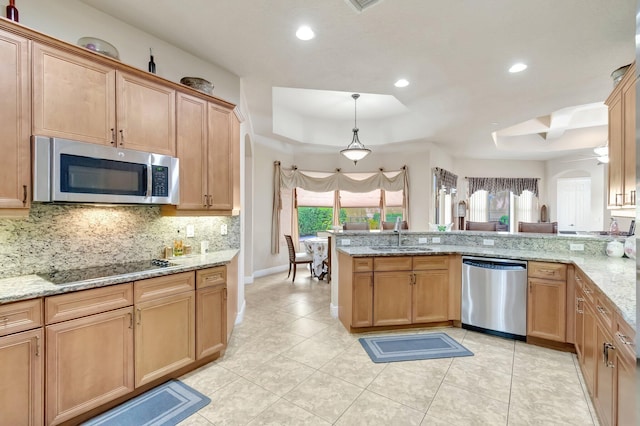 16211 Rosecroft Ter, Delray Beach, FL 33446 - kitchen featuring appliances with stainless steel finishes, a sink, arched walkways, backsplash, and a tray ceiling
