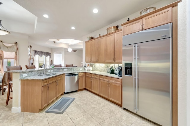 16211 Rosecroft Ter, Delray Beach, FL 33446 - kitchen with a sink, a kitchen breakfast bar, stainless steel appliances, a ceiling fan, and a peninsula