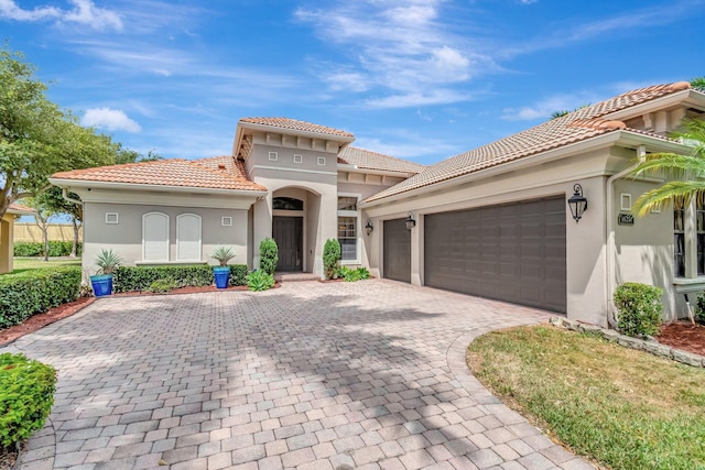 16211 Rosecroft Ter, Delray Beach, FL 33446 - mediterranean / spanish-style home with stucco siding, decorative driveway, a tile roof, and a garage