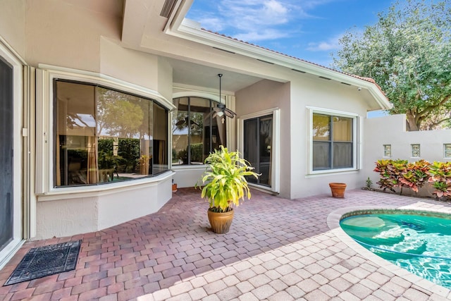 16211 Rosecroft Ter, Delray Beach, FL 33446 - back of property with a patio, visible vents, stucco siding, and an outdoor pool
