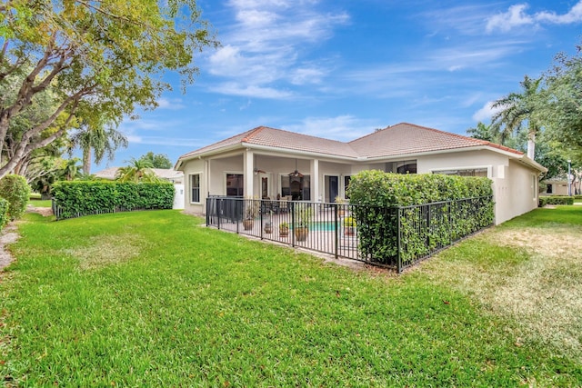 16211 Rosecroft Ter, Delray Beach, FL 33446 - rear view of property with fence, a ceiling fan, stucco siding, and a yard