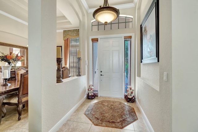 16211 Rosecroft Ter, Delray Beach, FL 33446 - foyer entrance featuring ornamental molding, a textured wall, light tile patterned flooring, baseboards, and arched walkways