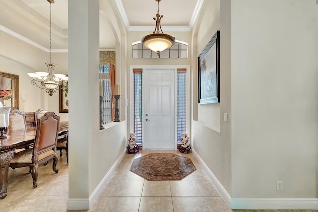 16211 Rosecroft Ter, Delray Beach, FL 33446 - foyer entrance with an inviting chandelier, ornamental molding, light tile patterned flooring, baseboards, and arched walkways