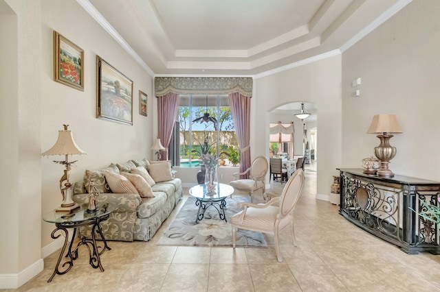 16211 Rosecroft Ter, Delray Beach, FL 33446 - living room with tile patterned floors, ornamental molding, a tray ceiling, and arched walkways